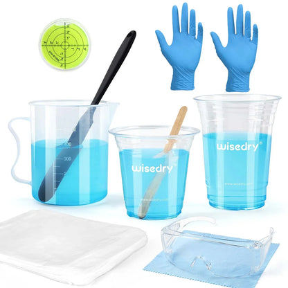 Epoxy resin crafting kit with large measuring cups, stir sticks, gloves, goggles, waterproof tablecloths, and mini level.
